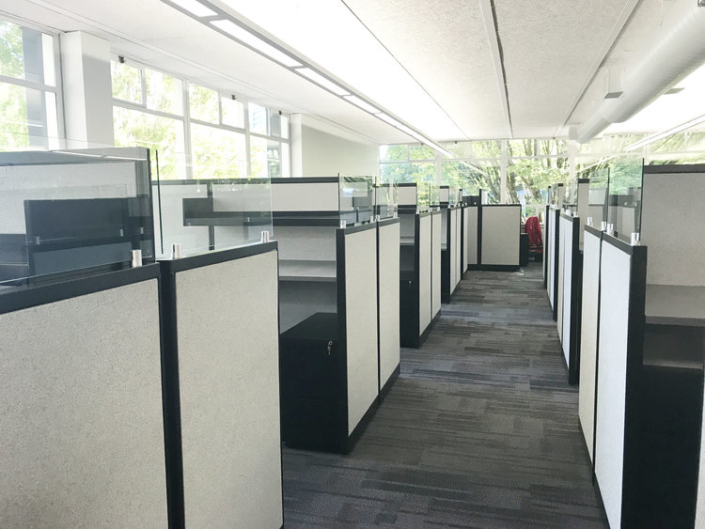 Bright office space with light grey cubicles
