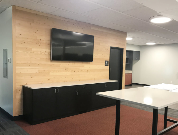 Meeting area with custom built-in base cabinets in dark wood for commercial office space