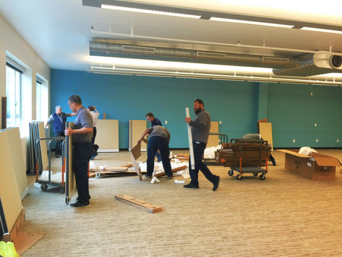 Installation team assembling cubicle workspaces