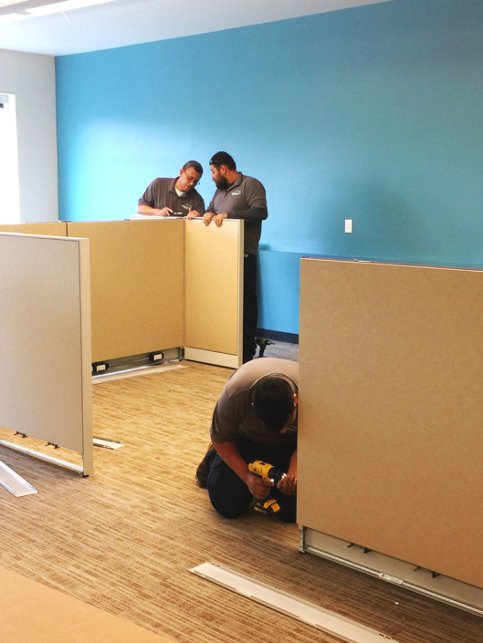 Installation team assembling cubicle workspaces