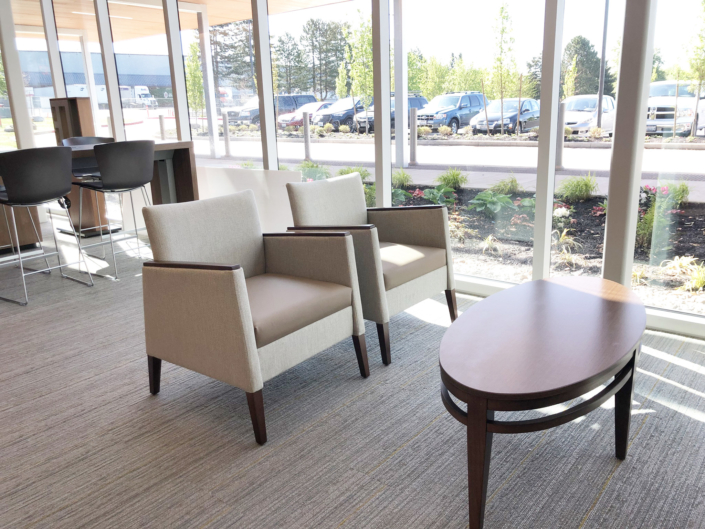 high back arm chairs in commercial office space with table
