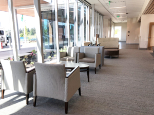 Bright open space with soft guest seating and coffee tables for commercial office space