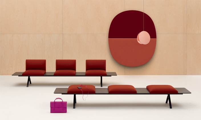 Arper wooden bench seating with red cushions for commercial seating area