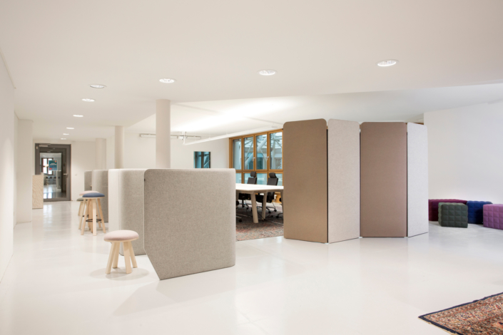Office interior with Buzzi Space brand upholstered privacy panels in neutral tones