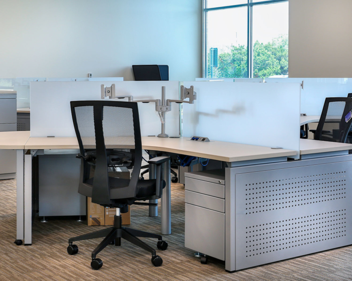 Clear Design ergonomic workspace with dual monitor arm