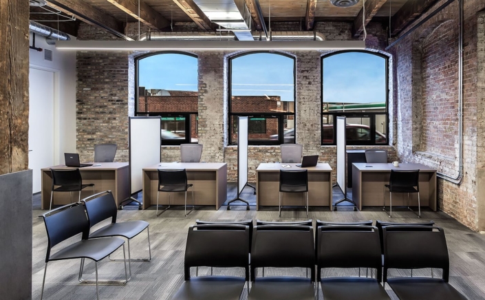 Brick office interior with white board partitions between workstations by KI brand