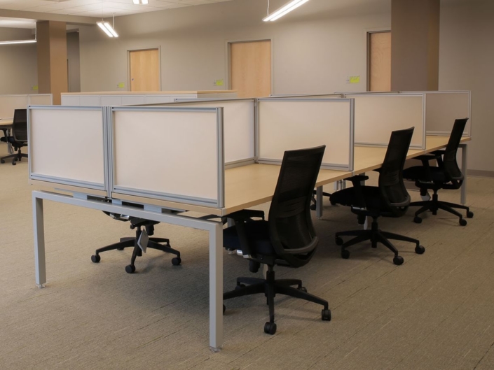 Office interior with multiple modular workstations with table top partitions by KI brand