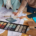 A team of designers examines material samples and color swatches to finalize design plans for a project.
