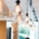 Clear glass pendant ceiling lights are hanging in a line and illuminating a bright, modern office space.