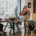 A diverse office team collaborates in an inclusive workspace, with one member in a wheelchair using a laptop.