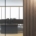 An office interior featuring glass walls, wooden panel accents, and minimalist workstations in a high-rise building.