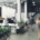 A modern and gray open space corporate office interior space with blurred business colleagues walking around.