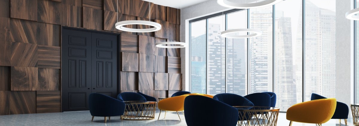 A modern luxury office room with dark wooden textured walls and yellow and blue modern office decor chairs.