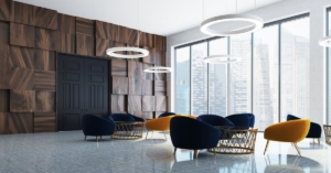 A modern luxury office room with dark wooden textured walls and yellow and blue modern office decor chairs.