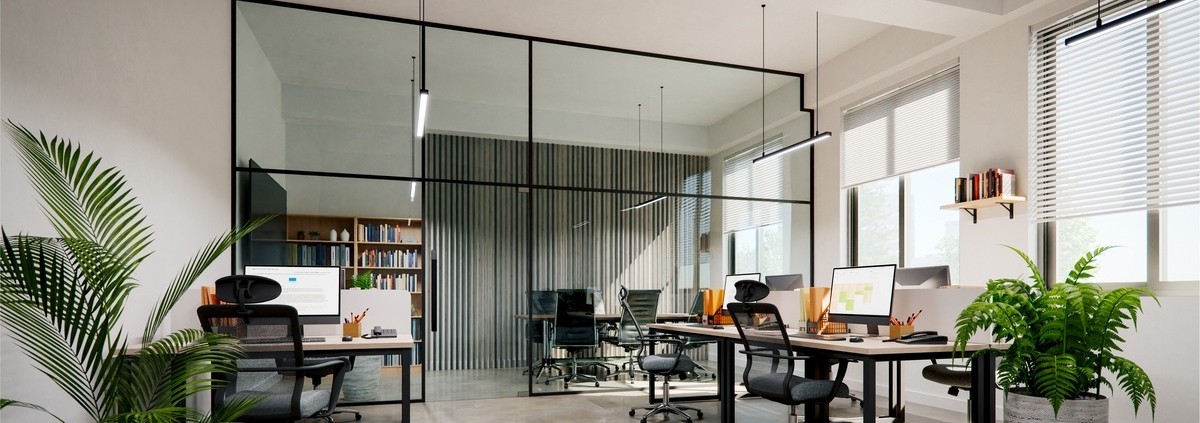 A close-up of a modern small office interior with white walls and concrete floors, with modern furniture and plants.