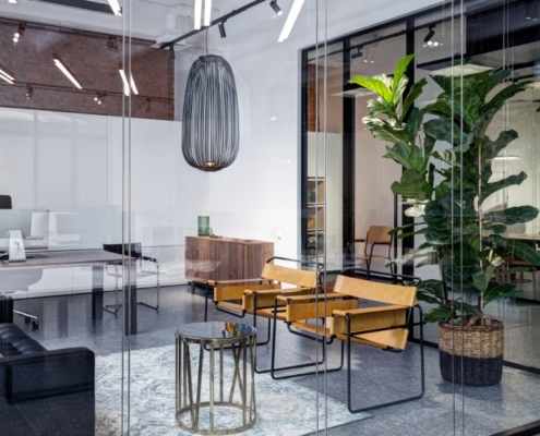 A close-up interior meeting room in a modern office space. The office is decorated with plants and modern furniture.